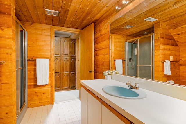 3949 Waldenwood Dr, Ann Arbor, MI 48105 - bathroom featuring wood walls, wooden ceiling, tile patterned flooring, vanity, and a shower stall