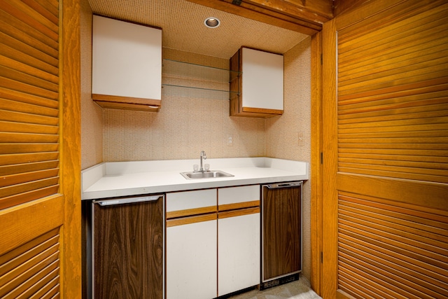 3949 Waldenwood Dr, Ann Arbor, MI 48105 - kitchen with a sink, light countertops, white cabinetry, and fridge