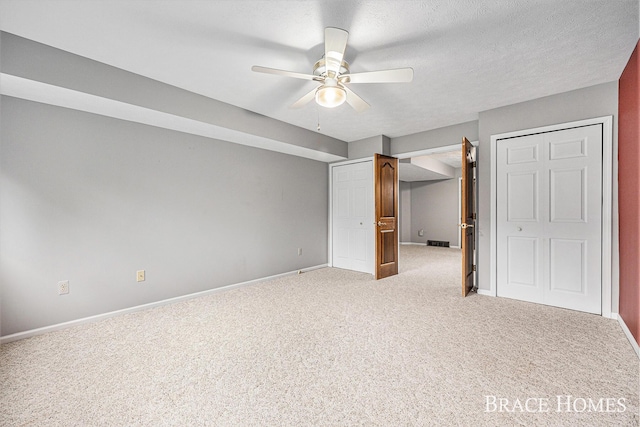 unfurnished bedroom with carpet floors, baseboards, and a ceiling fan