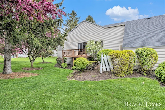 view of grassy yard featuring a wooden deck