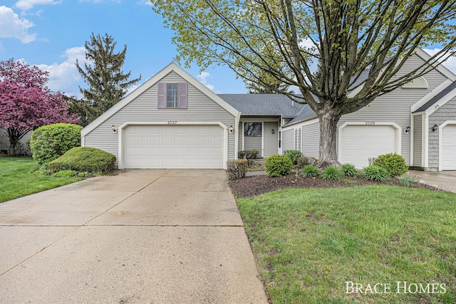 view of front of house with a front yard and concrete driveway