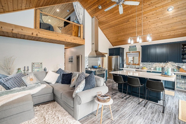 17389 Rapids Dr, Hersey, MI 49639 - living area with high vaulted ceiling, wood ceiling, beverage cooler, ceiling fan, and light wood-type flooring