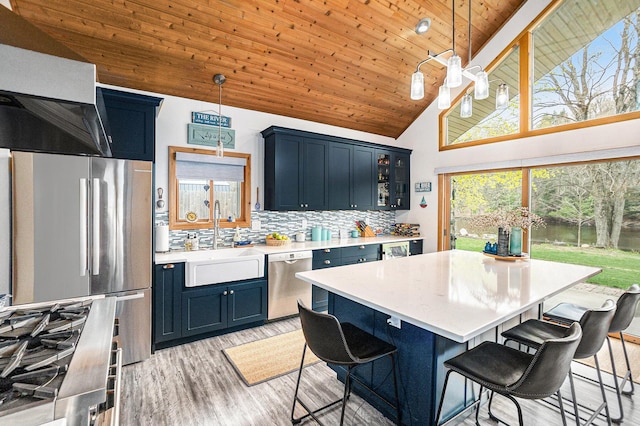17389 Rapids Dr, Hersey, MI 49639 - kitchen featuring stainless steel appliances, a sink, wooden ceiling, blue cabinets, and light countertops