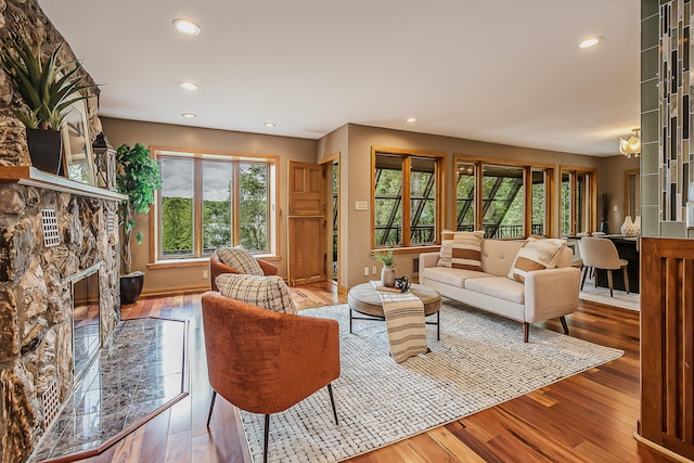 10985 E Pleasant Lake Rd, Manchester, MI 48158 - living area with hardwood / wood-style floors, a stone fireplace, and recessed lighting