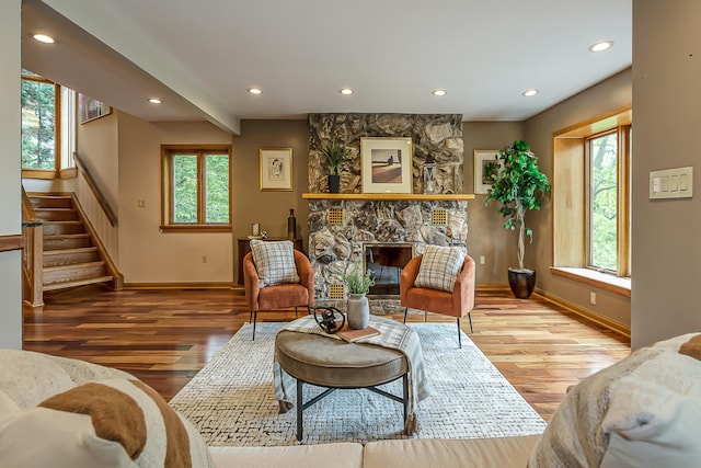 10985 E Pleasant Lake Rd, Manchester, MI 48158 - living room featuring baseboards, recessed lighting, wood finished floors, a stone fireplace, and stairs