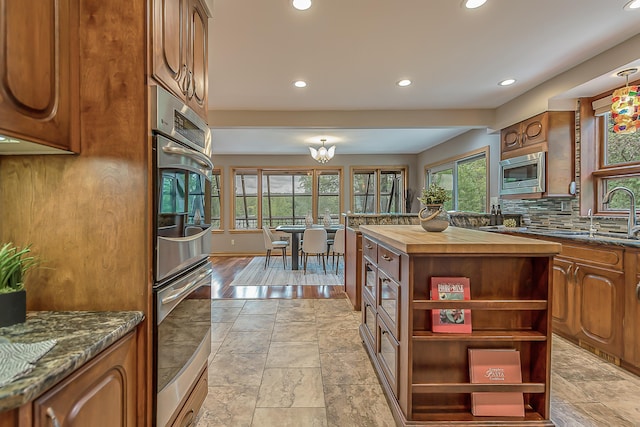 10985 E Pleasant Lake Rd, Manchester, MI 48158 - kitchen featuring healthy amount of natural light, recessed lighting, open shelves, appliances with stainless steel finishes, and butcher block counters
