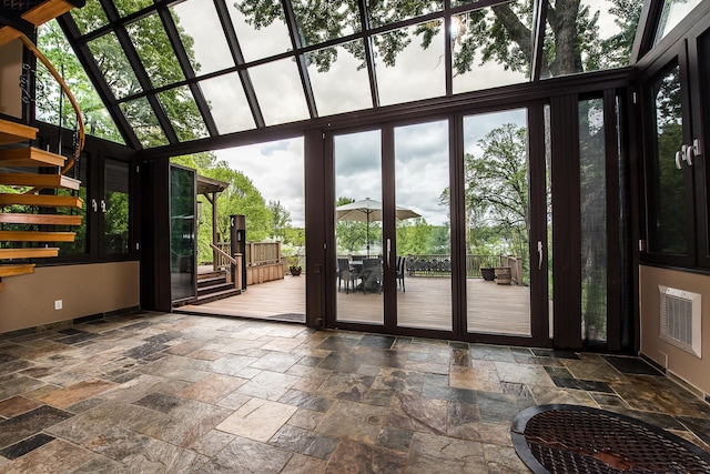 10985 E Pleasant Lake Rd, Manchester, MI 48158 - doorway featuring stone tile flooring, stairs, baseboards, healthy amount of natural light, and a towering ceiling