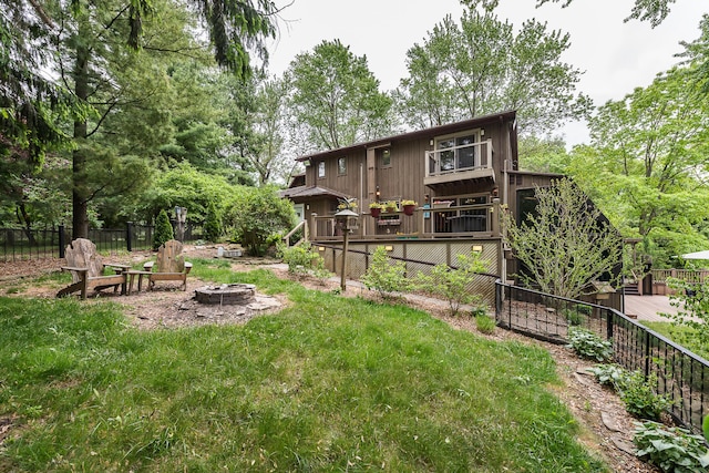 10985 E Pleasant Lake Rd, Manchester, MI 48158 - rear view of property featuring an outdoor fire pit and a wooden deck
