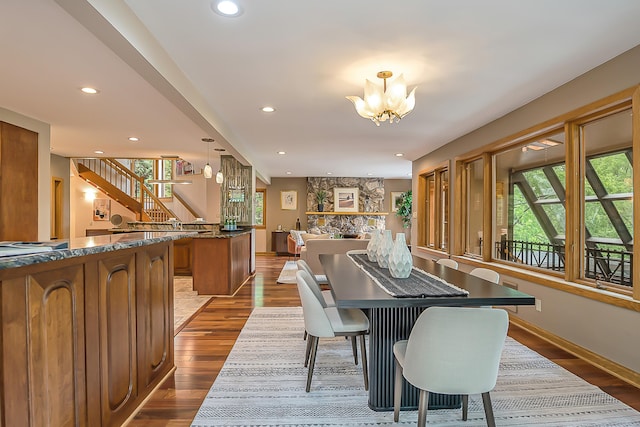 10985 E Pleasant Lake Rd, Manchester, MI 48158 - dining room with a chandelier, recessed lighting, stairs, wood finished floors, and baseboards