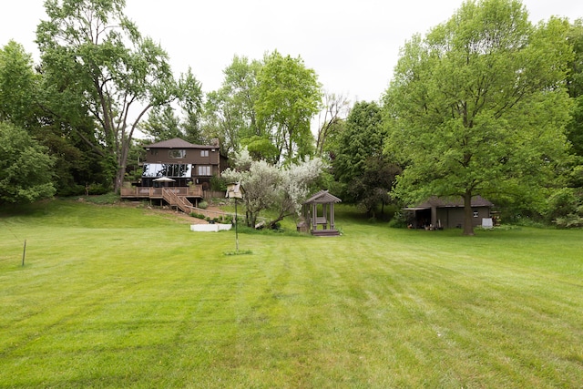 10985 E Pleasant Lake Rd, Manchester, MI 48158 - view of grassy yard with a deck, a gazebo, and view of scattered trees
