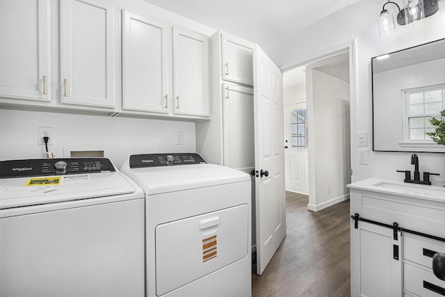 laundry room featuring a sink, cabinet space, washer and dryer, dark wood-style floors, and baseboards
