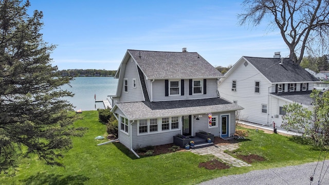 447 Paradise Ln, Horton, MI 49246 - bungalow-style house featuring roof with shingles, a front lawn, and a water view