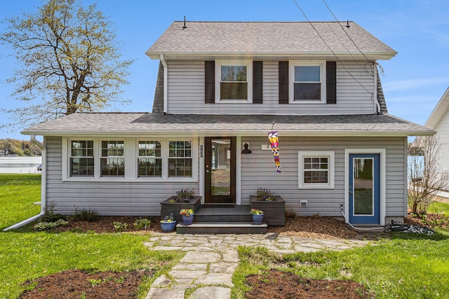 447 Paradise Ln, Horton, MI 49246 - traditional-style home featuring a front lawn and a shingled roof