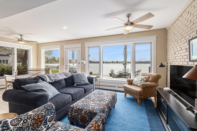 447 Paradise Ln, Horton, MI 49246 - carpeted living room featuring a ceiling fan and baseboard heating