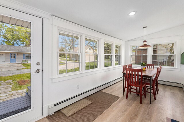 447 Paradise Ln, Horton, MI 49246 - dining area with a baseboard radiator, light wood finished floors, vaulted ceiling, plenty of natural light, and recessed lighting