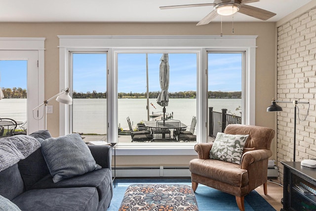 447 Paradise Ln, Horton, MI 49246 - sitting room featuring a baseboard radiator, ceiling fan, a water view, and brick wall