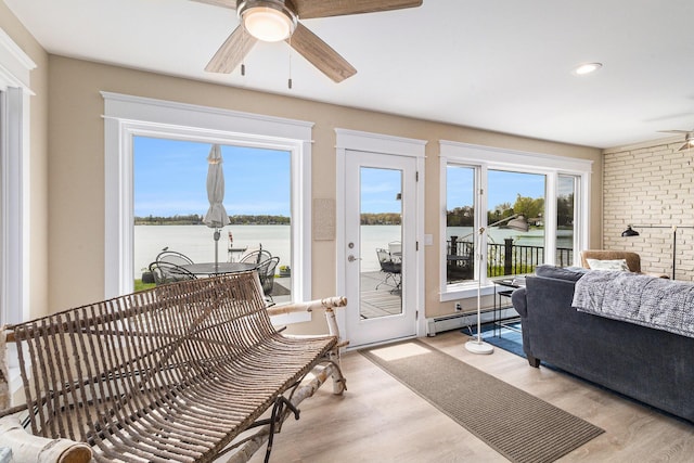 447 Paradise Ln, Horton, MI 49246 - sunroom / solarium featuring a baseboard radiator, french doors, and a water view