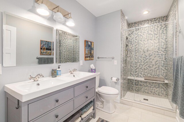 447 Paradise Ln, Horton, MI 49246 - bathroom with a stall shower, toilet, tile patterned flooring, and double vanity