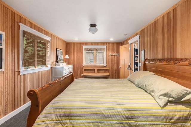 447 Paradise Ln, Horton, MI 49246 - bedroom with wood walls, carpet floors, and baseboards