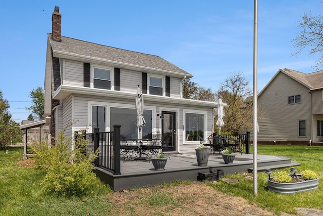 447 Paradise Ln, Horton, MI 49246 - back of house featuring a deck, a chimney, and a lawn