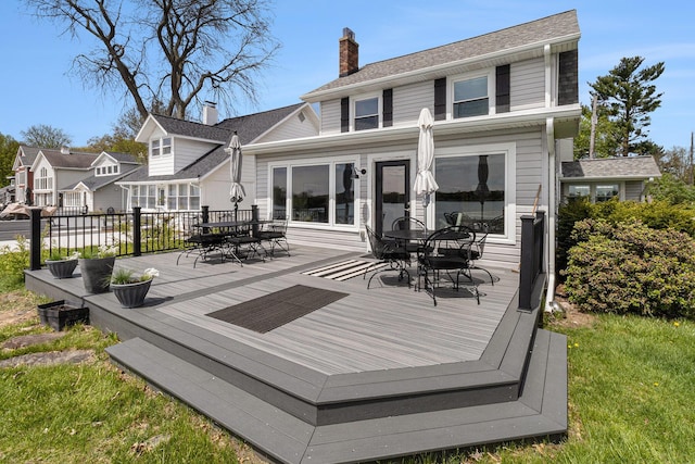 447 Paradise Ln, Horton, MI 49246 - back of house featuring outdoor dining space, a deck, and a chimney