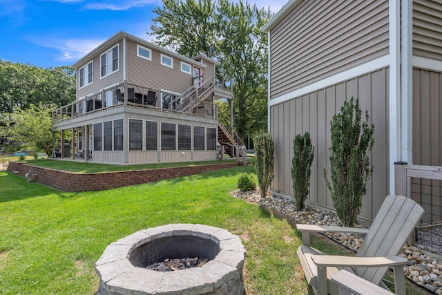67592 95th Ave, Dowagiac, MI 49047 - back of house featuring an outdoor fire pit, a lawn, and a balcony