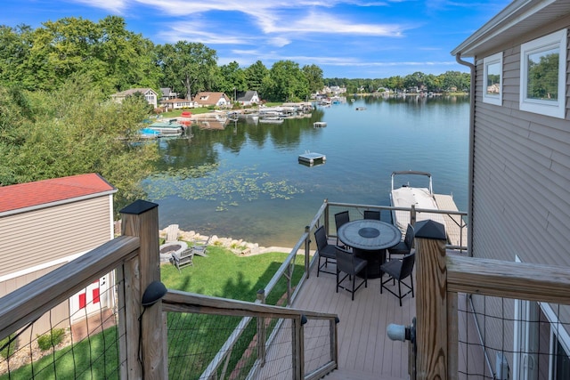 67592 95th Ave, Dowagiac, MI 49047 - dock with outdoor dining area, a lawn, and a deck with water view