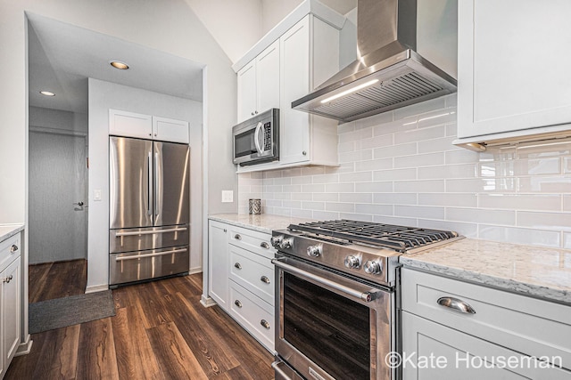 1334 Thornberry Ct W, Grand Rapids, MI 49546 - kitchen featuring white cabinets, dark wood-style flooring, wall chimney range hood, appliances with stainless steel finishes, and tasteful backsplash