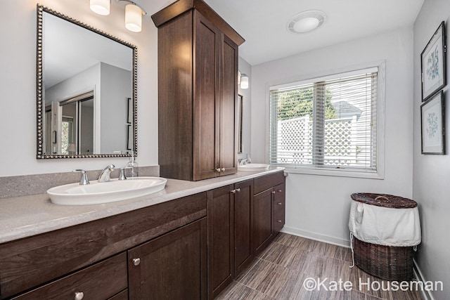1334 Thornberry Ct W, Grand Rapids, MI 49546 - full bath with a sink, double vanity, baseboards, and wood finished floors