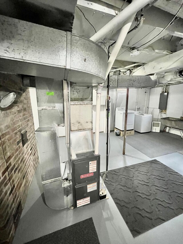 5795 S M37 Hwy, Hastings, MI 49058 - unfinished basement with brick wall, heating unit, and independent washer and dryer