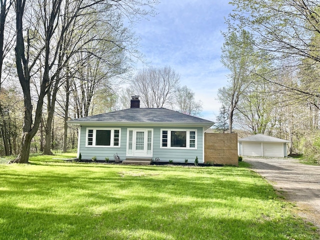 5795 S M37 Hwy, Hastings, MI 49058 - view of front of house with a front lawn, a chimney, and a detached garage
