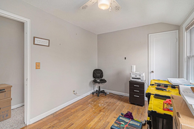 bedroom with vaulted ceiling, light wood-style flooring, baseboards, and a ceiling fan