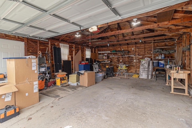 garage with a workshop area and a garage door opener
