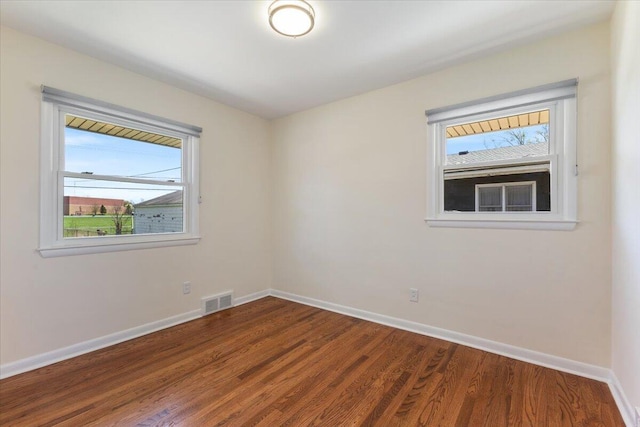 1610 Saunders Cres, Ann Arbor, MI 48103 - unfurnished room featuring baseboards, visible vents, plenty of natural light, and wood finished floors