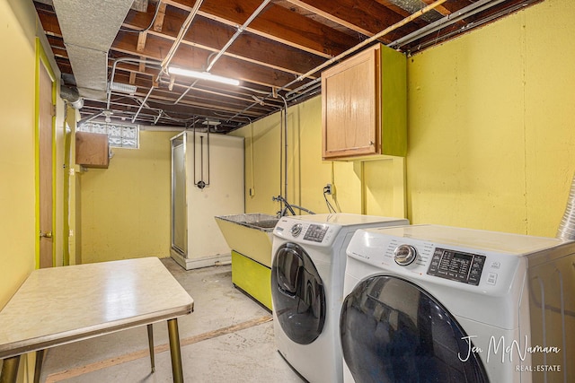 washroom with independent washer and dryer and cabinet space