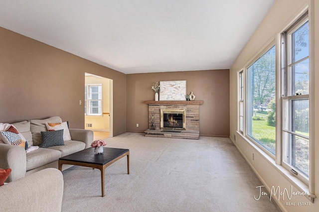 living room with carpet flooring, a fireplace, and baseboards