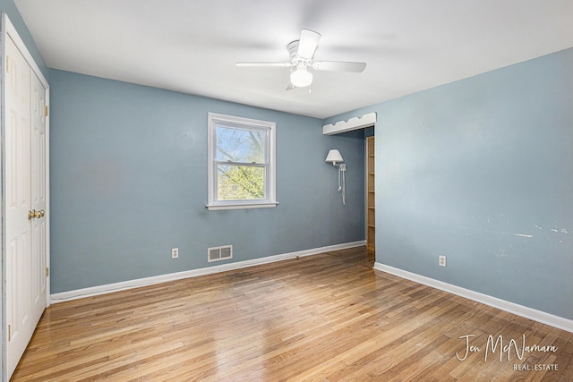 unfurnished bedroom with wood finished floors, baseboards, and ceiling fan