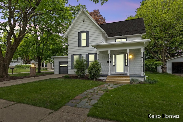 510 Division St, Big Rapids, MI 49307 - view of front of house featuring driveway, roof with shingles, a front yard, covered porch, and brick siding