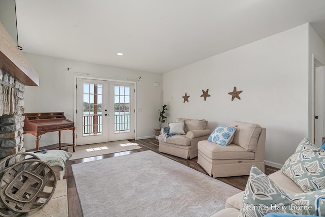 7177 Longview Ct, Delton, MI 49046 - living room with french doors, wood finished floors, baseboards, recessed lighting, and a water view