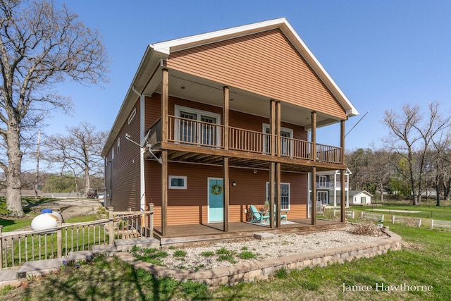 7177 Longview Ct, Delton, MI 49046 - rear view of house with a balcony, a porch, and a lawn