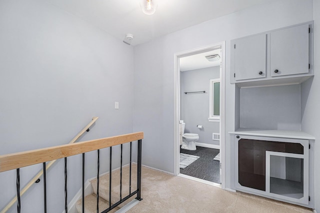 bathroom with toilet and baseboards