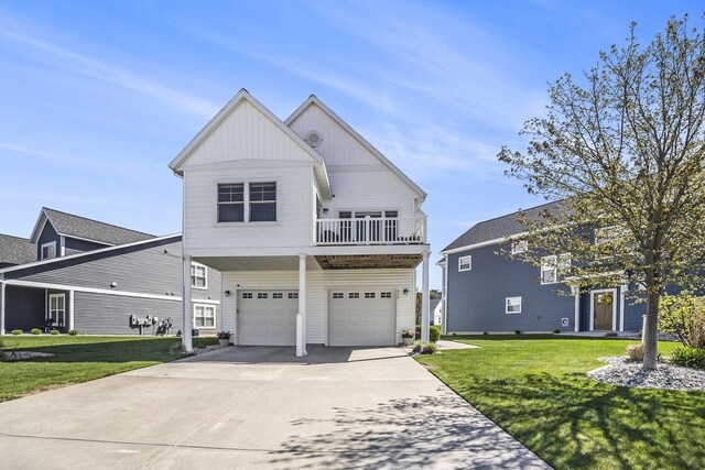 view of front of property featuring an attached garage, a balcony, driveway, a front lawn, and board and batten siding