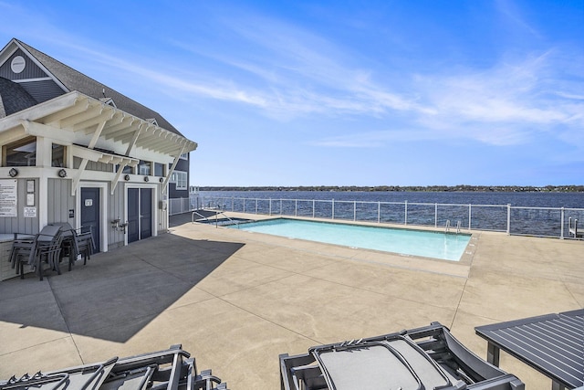 community pool featuring fence and a patio