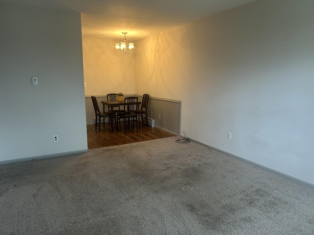2140 Banner Dr SW, Wyoming, MI 49509 - unfurnished dining area featuring carpet, a notable chandelier, and baseboards
