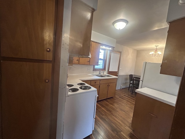 2140 Banner Dr SW, Wyoming, MI 49509 - kitchen with an inviting chandelier, a sink, dark wood finished floors, white appliances, and light countertops