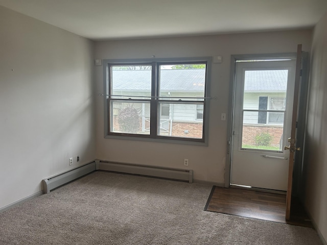 2140 Banner Dr SW, Wyoming, MI 49509 - doorway to outside featuring a baseboard radiator and carpet floors