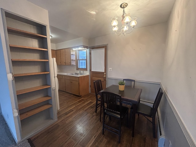 2140 Banner Dr SW, Wyoming, MI 49509 - dining area with dark wood-style flooring, an inviting chandelier, and wainscoting