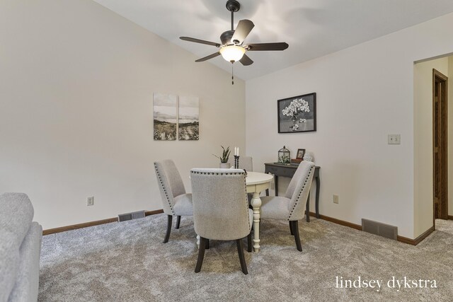 1013 Country Gdns NW, Walker, MI 49534 - carpeted dining area with vaulted ceiling, visible vents, baseboards, and a ceiling fan