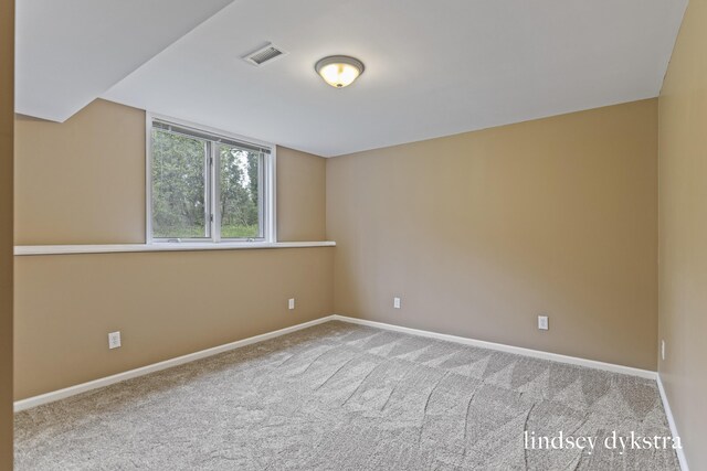 1013 Country Gdns NW, Walker, MI 49534 - spare room featuring carpet, visible vents, and baseboards