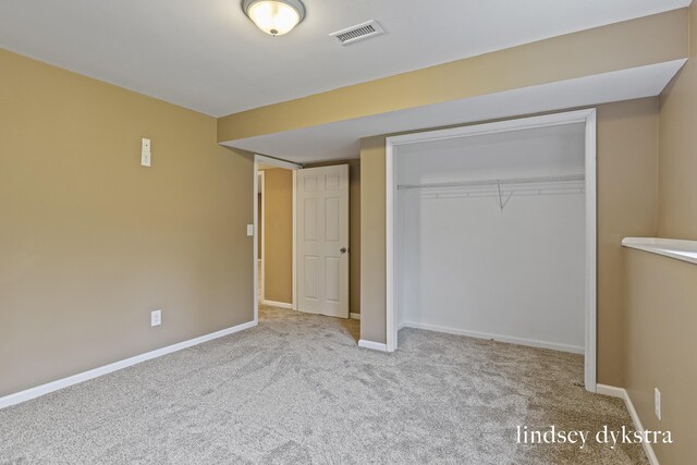 1013 Country Gdns NW, Walker, MI 49534 - unfurnished bedroom featuring baseboards, a closet, visible vents, and carpet